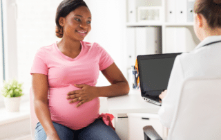 Pregnant Woman Consulting a Doctor in a Clinic | During Your Prenatal Pediatrician Visit